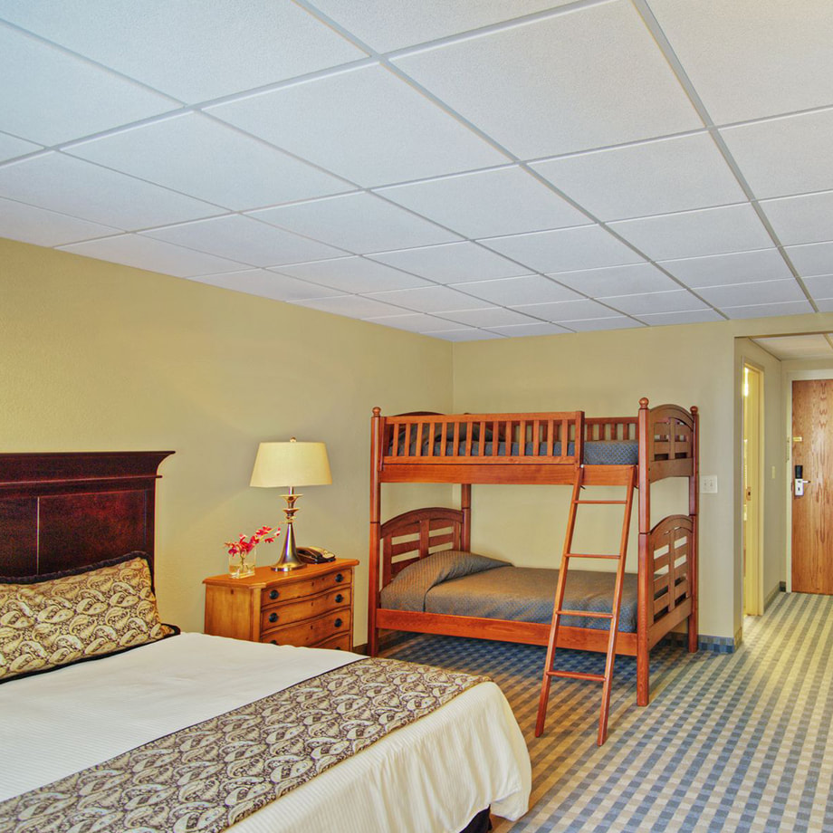 A huge room with a king bed and a bunk bed